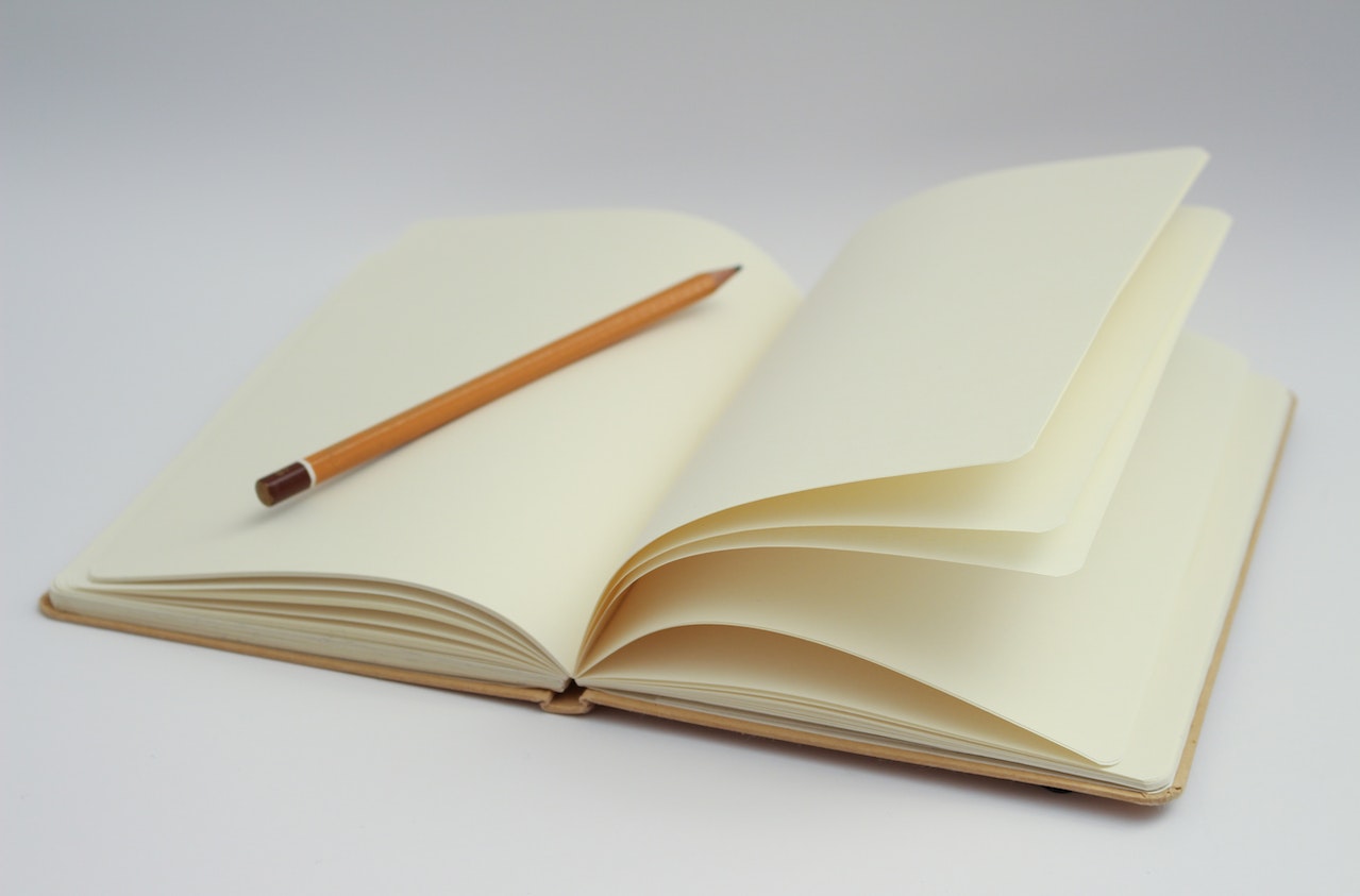 A photo of a notebook and pencil